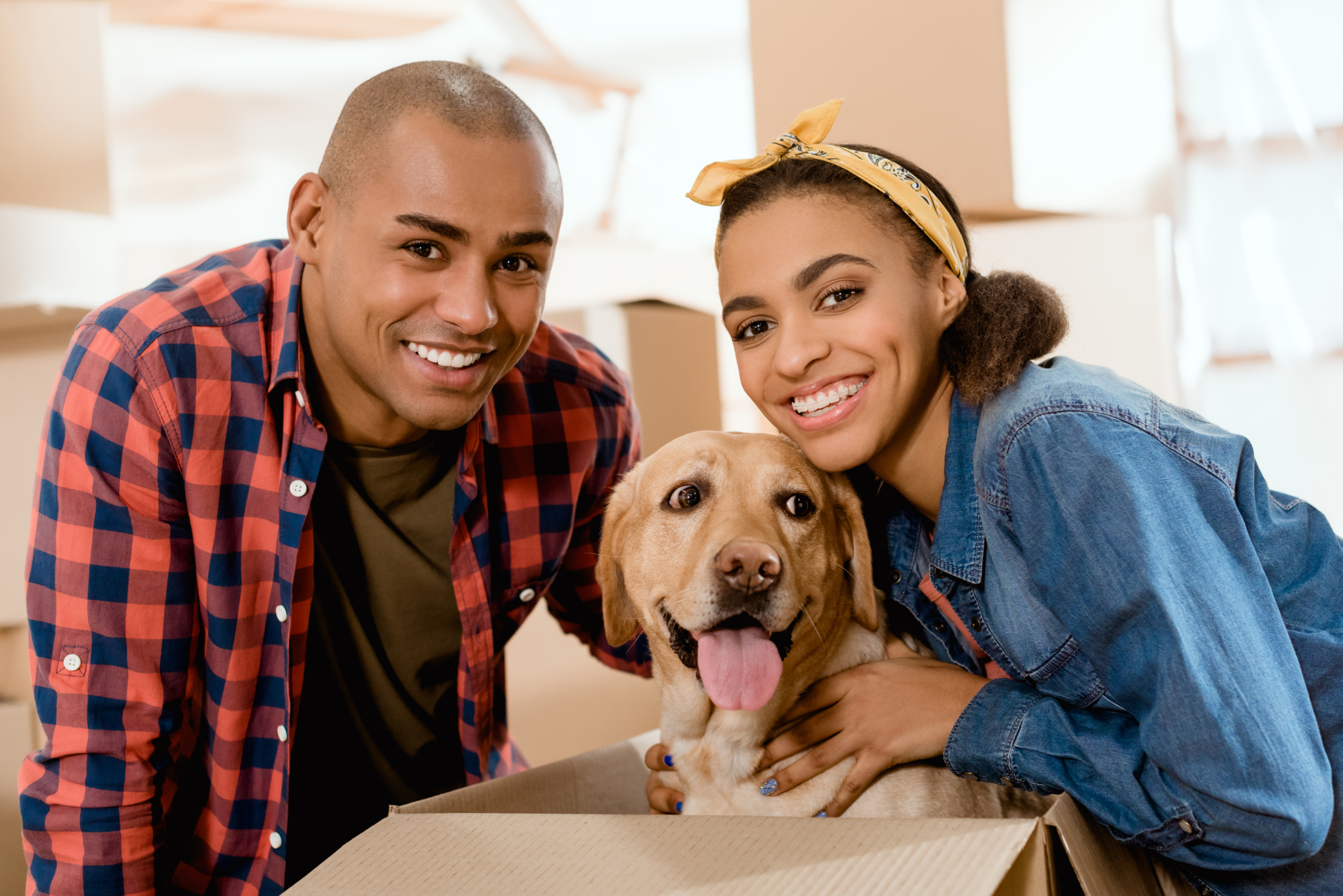 Young couple and dog moving into a new home